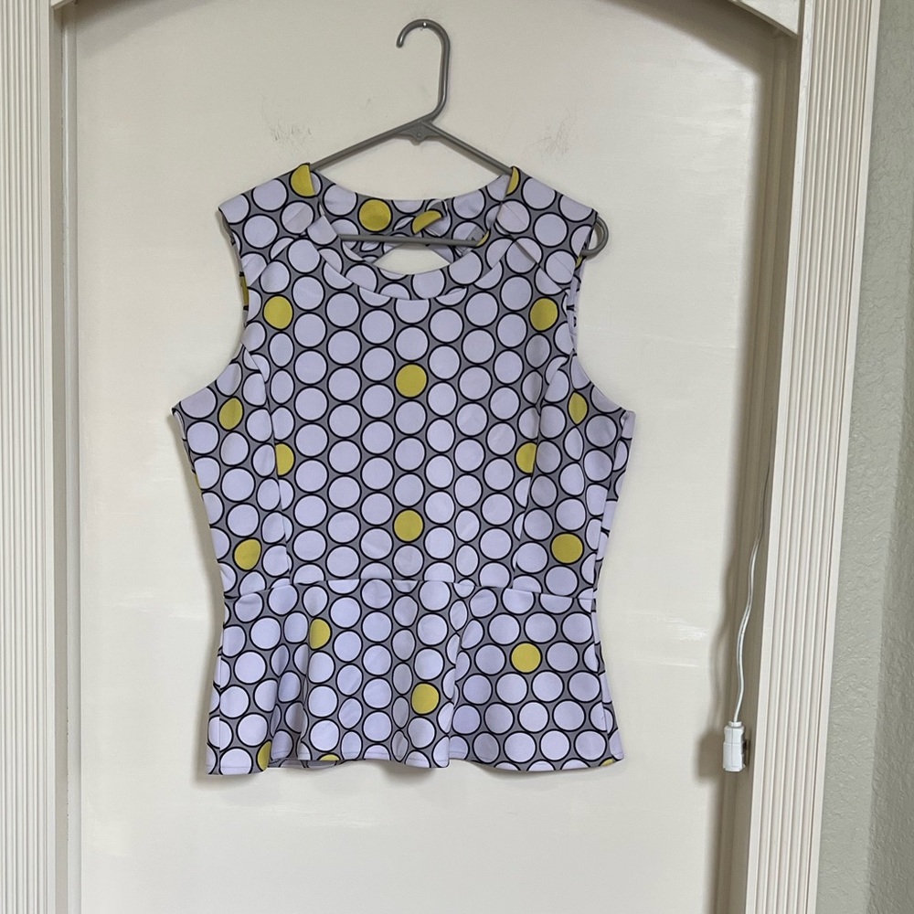 Black white and yellow patterned peplum sleeveless blouse